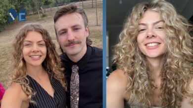 Nancy Mitchell smiling in her signature curly blonde hairstyle, standing next to her partner.