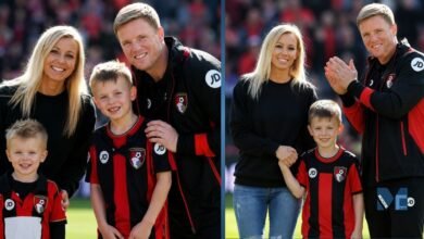 Eddie Howe smiling with his wife Vicki Howe and their two elder sons, Rocky and Harry Howe, wearing AFC Bournemouth kits on the pitch.