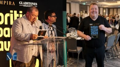Gary Carr, Director of Empira Ltd, standing at the podium and celebrating a win at the British Parking Awards event.