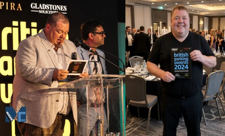Gary Carr, Director of Empira Ltd, standing at the podium and celebrating a win at the British Parking Awards event.