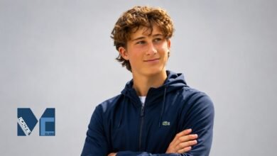 Huckleberry Grylls wearing a navy blue hoodie in a casual outdoor portrait
