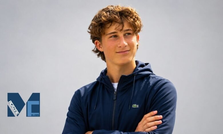 Huckleberry Grylls wearing a navy blue hoodie in a casual outdoor portrait