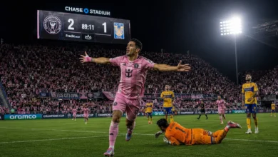 Luis Suarez celebrating his match-winning penalty goal in the 89th minute for Inter Miami against Tigres UANL at Chase Stadium scoreboard showing 2-1.
