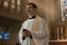Actor Patrick Carr, younger brother of Jimmy Carr, dressed as a priest holding a small red book in a church setting.