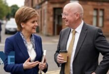 Peter Murrell and Nicola Sturgeon speaking together outdoors during a public appearance in Scotland