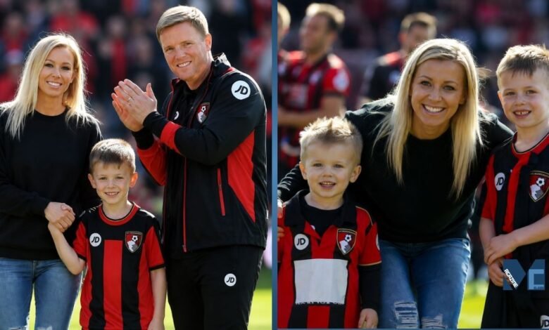 Vicki Howe smiling with her husband Eddie Howe and their children on the football pitch wearing AFC Bournemouth kits.