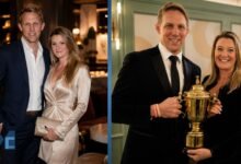 Annie Moody and her husband Lewis Moody smiling and holding a golden rugby trophy together at an event.