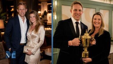 Annie Moody and her husband Lewis Moody smiling and holding a golden rugby trophy together at an event.