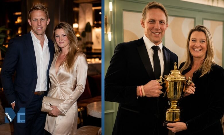 Annie Moody and her husband Lewis Moody smiling and holding a golden rugby trophy together at an event.