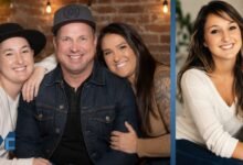 August Anna Brooks smiling in a family portrait alongside her father Garth Brooks and family members, highlighting her private life and family background.