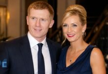 A formal portrait of Claire Froggatt and her former husband, Manchester United legend Paul Scholes, smiling together at an evening event.