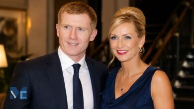 A formal portrait of Claire Froggatt and her former husband, Manchester United legend Paul Scholes, smiling together at an evening event.