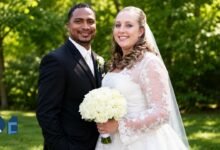 Corrie Bird and Trent Batson posing together during their wedding ceremony in Indiana.