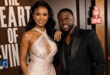 Eniko Hart smiling elegantly in a champagne dress while posing alongside her husband Kevin Hart at a Hollywood event.