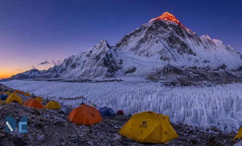 Everest Advanced Base Camp at dawn with colorful expedition tents, East Rongbuk Glacier ice formations, and the illuminated north face of Mount Everest in Tibet.