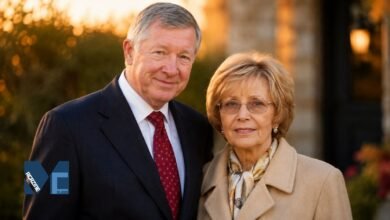 Sir Alex Ferguson and his wife Lady Cathy Ferguson smiling together in a warm outdoor portrait.