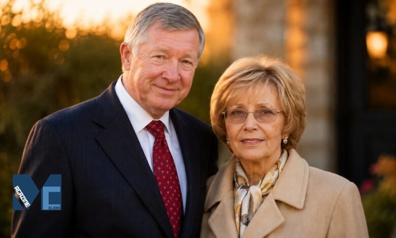 Sir Alex Ferguson and his wife Lady Cathy Ferguson smiling together in a warm outdoor portrait.