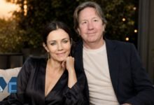Real estate finance executive Mark Fluent and his wife, actress Justine Bateman, sitting together and smiling in a relaxed outdoor setting.