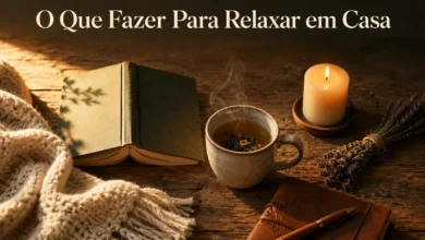 An aesthetic flat-lay of home relaxation items on a bed including an open journal with pen, a warm mug of coffee, a burning candle, and a green plant under soft warm lighting.