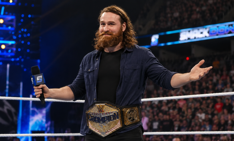 Sami Zayn holding a WWE championship during an arena appearance in 2026.