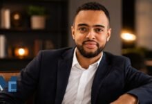 A professional portrait of Sened Teame, CFO of Cloud Nine AB and older brother of footballer Alexander Isak, sitting in a modern office.